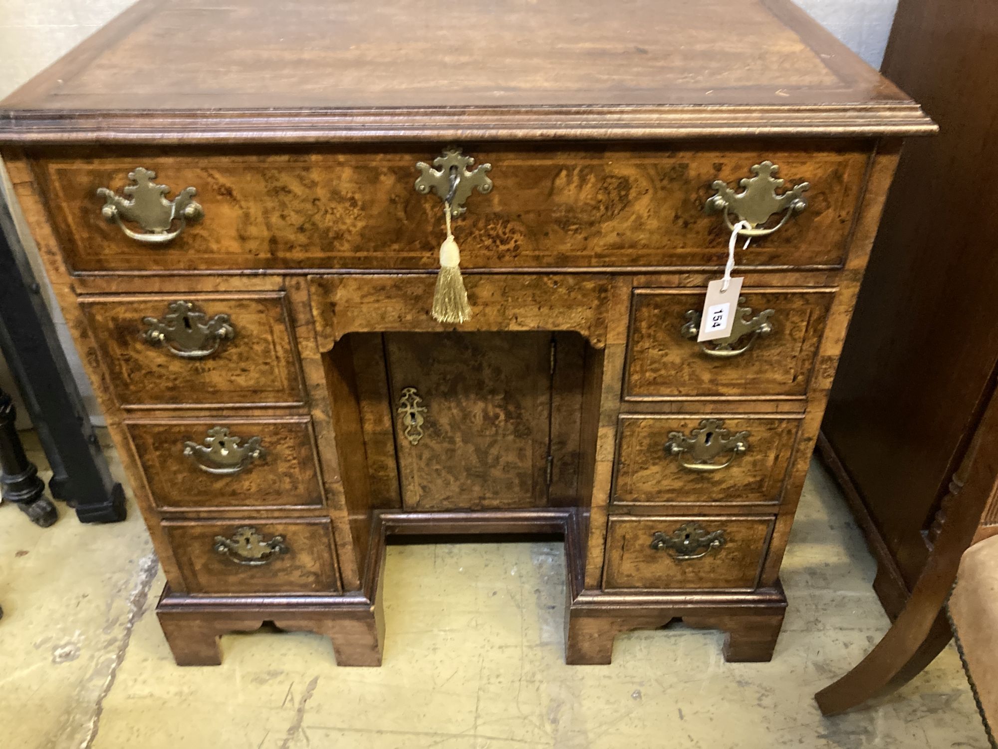 A George I style walnut kneehole desk, width 82cm, depth 49cm, height 78cm